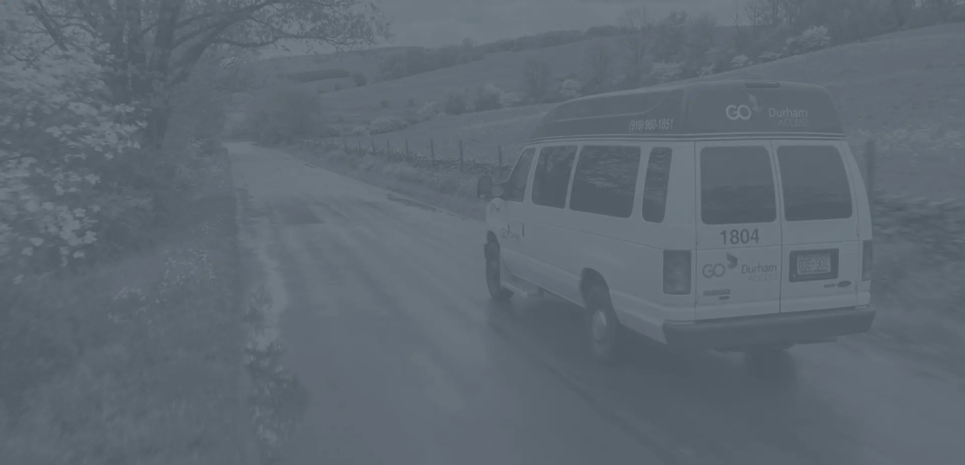 background image of GoDurham ACCESS van driving